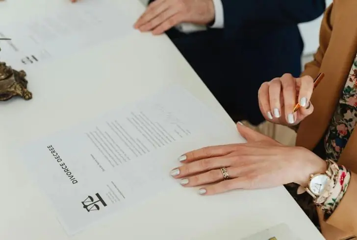 Divorce decree document with wedding rings
