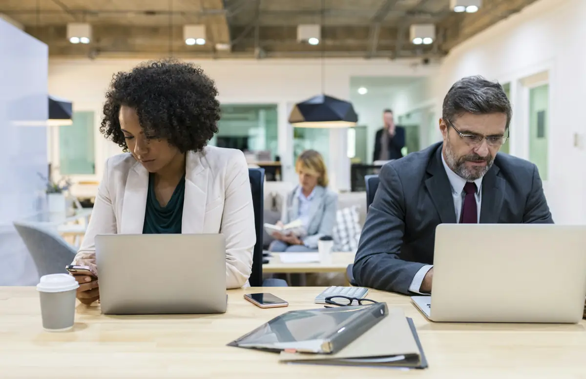 man sitting beside woman using smartphone