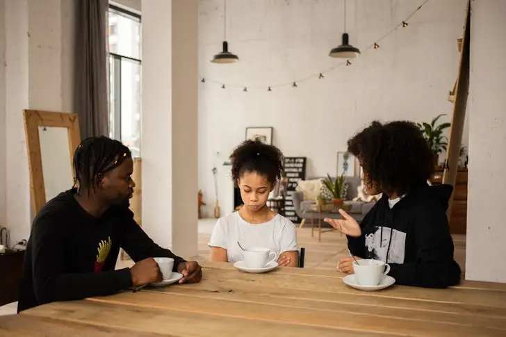 Family separation - Family having an argument at table.