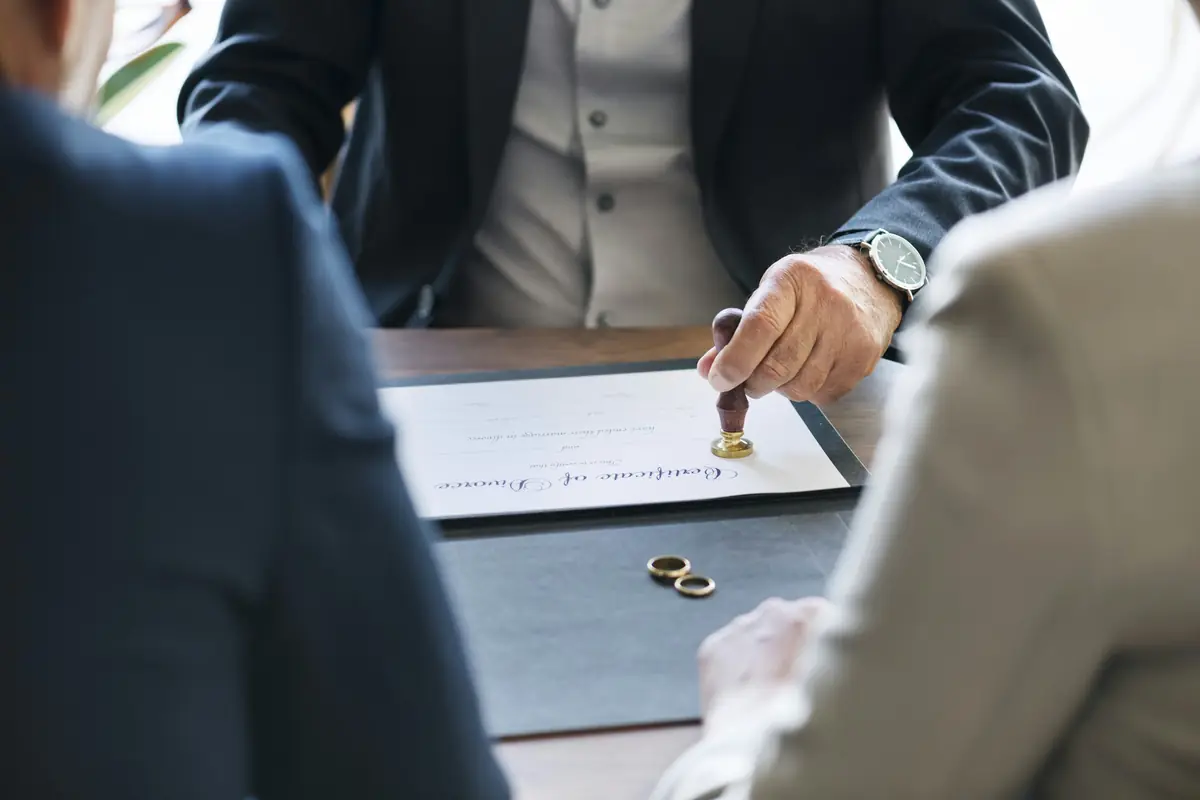 person stamping on paper white sitting near desk